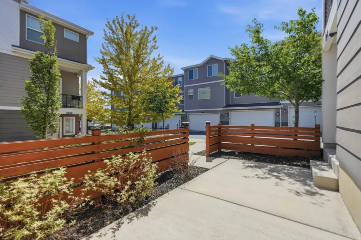 Concrete patio with a slatted privacy fence