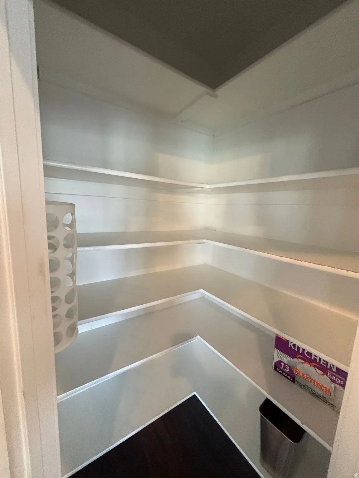 Built-in shelving with multiple levels, dark wood-finish flooring
