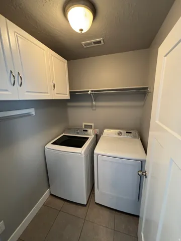 White upper cabinetry with brushed nickel hardware