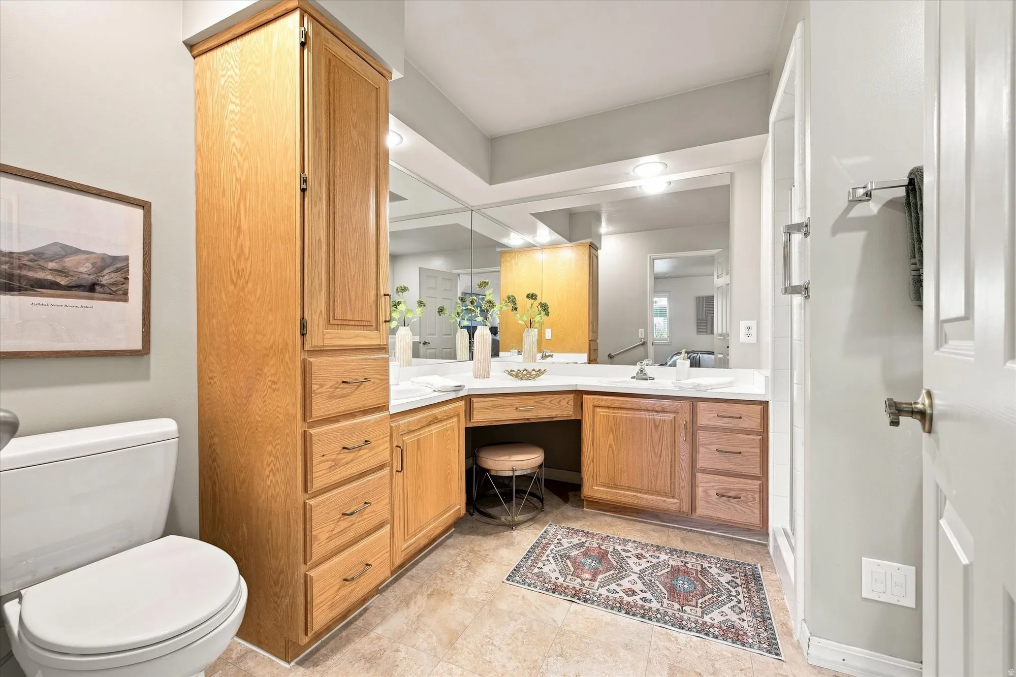 Primary bathroom with shower, double vanity, and accessible walk-in bathtub.