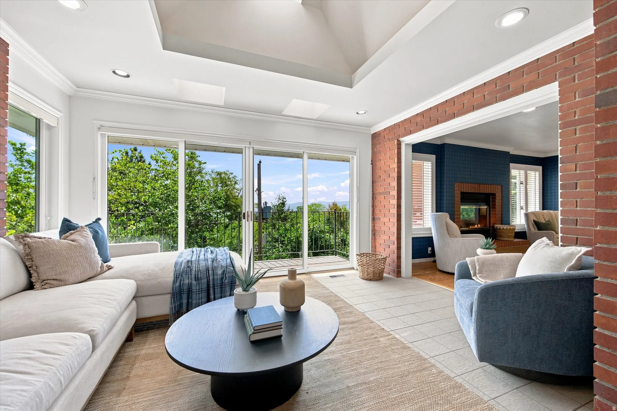 This might become your favorite spot - double sliding glass doors open to a balcony with tree-top and valley views.
