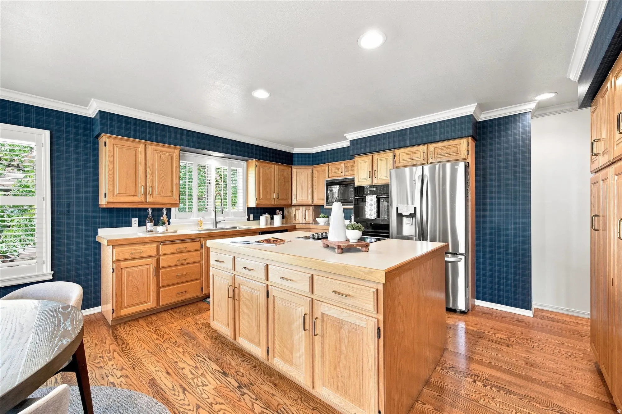 Light-filled, generously sized kitchen with an island, abundant storage, fireplace, and room to gather.