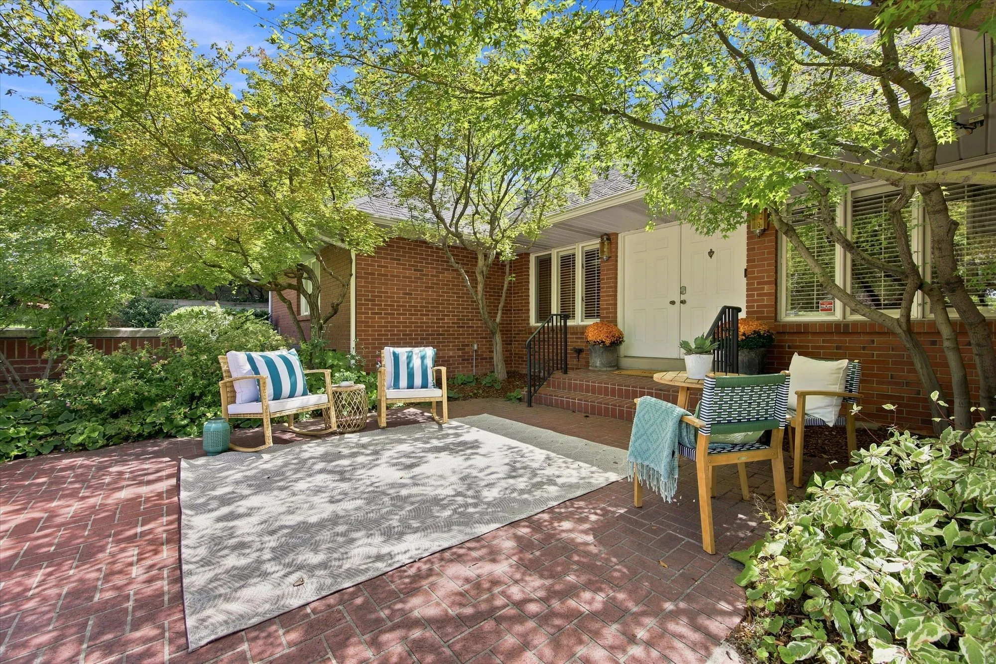 Double door front entry with an inviting front patio.