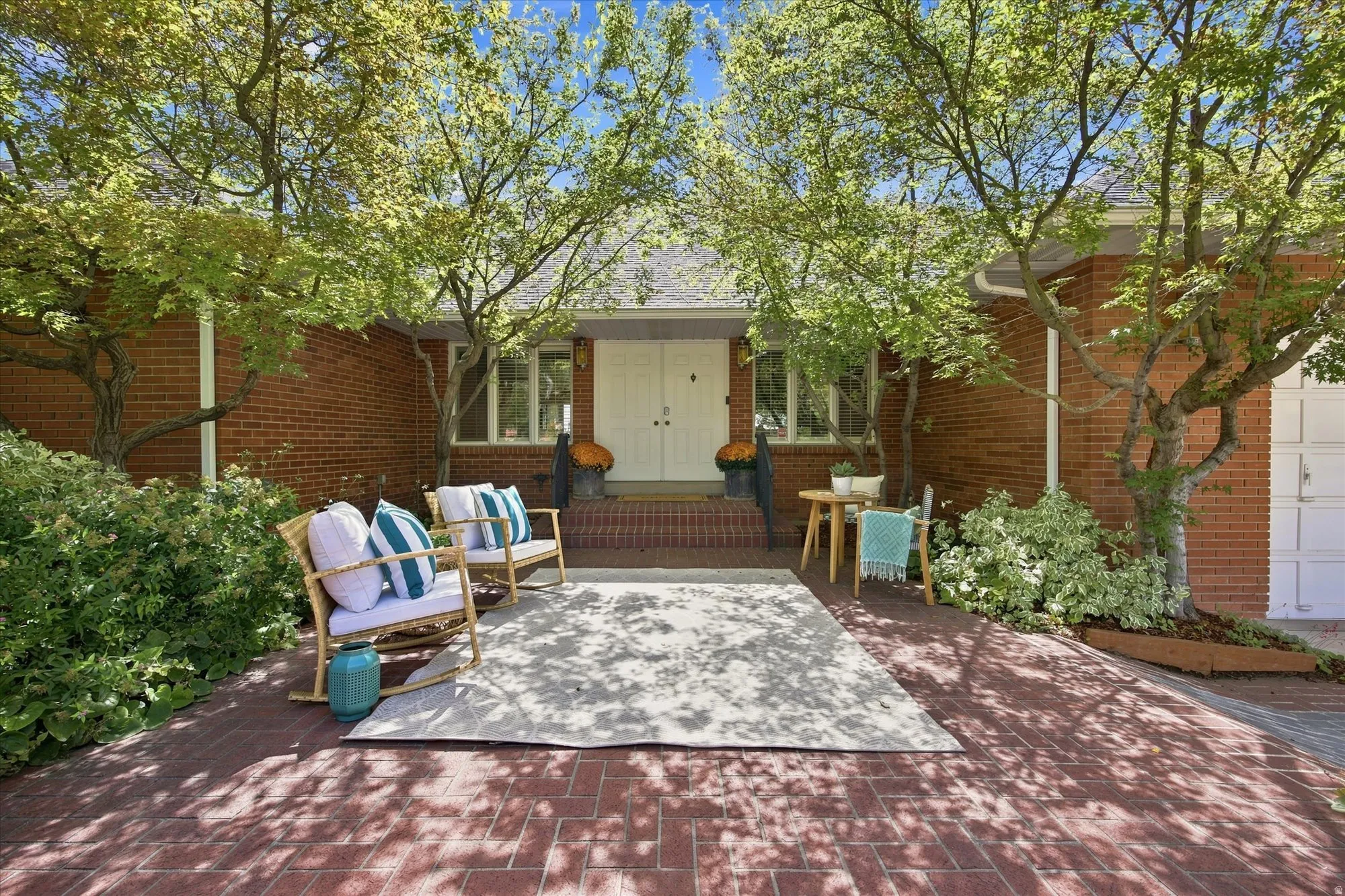Double door front entry with an inviting front patio.