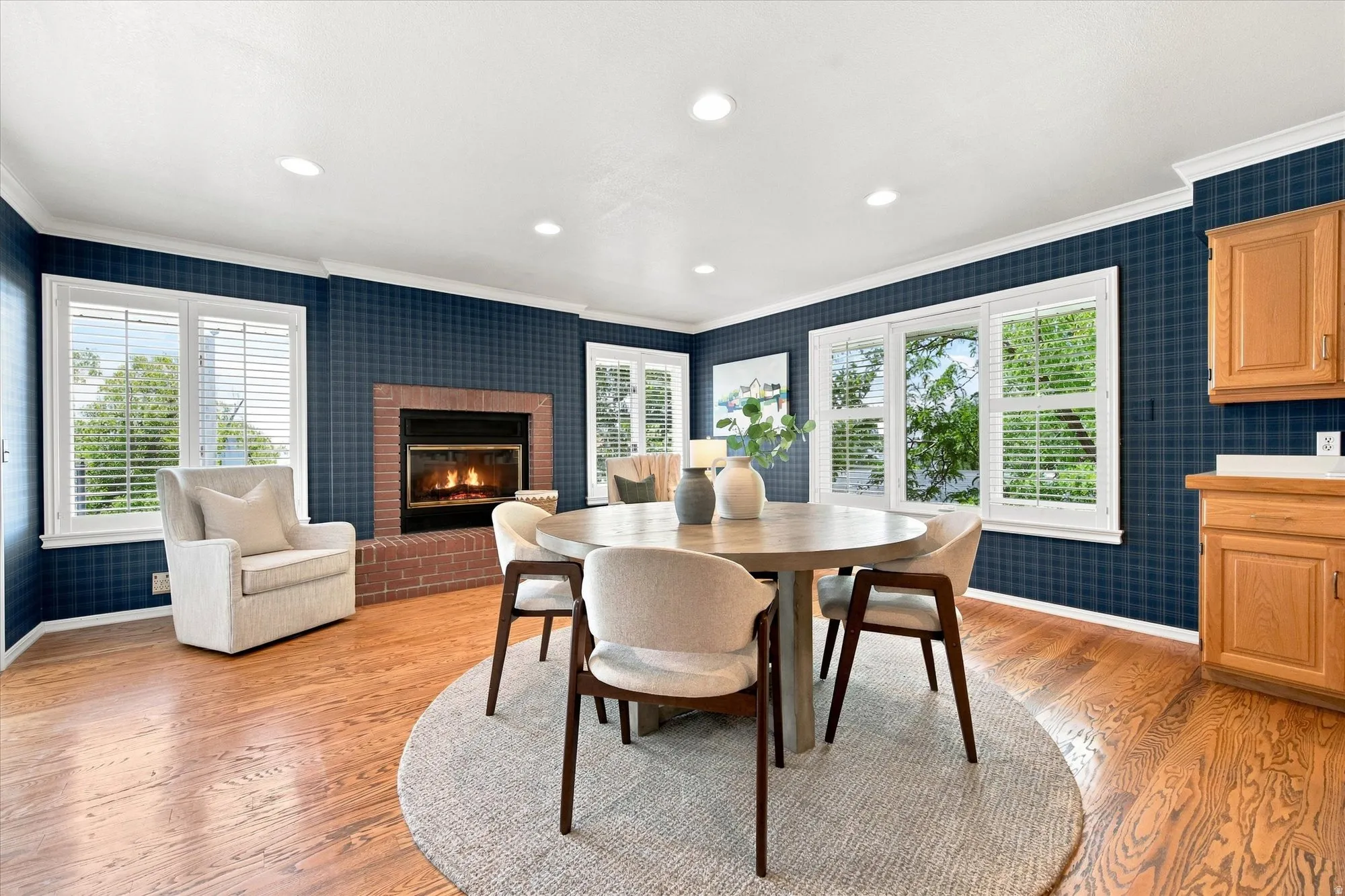 Light-filled, generously sized kitchen with an island, abundant storage, fireplace, and room to gather.