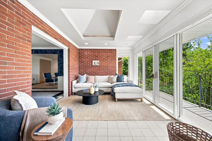This might become your favorite spot - double sliding glass doors open to a balcony with tree-top and valley views.