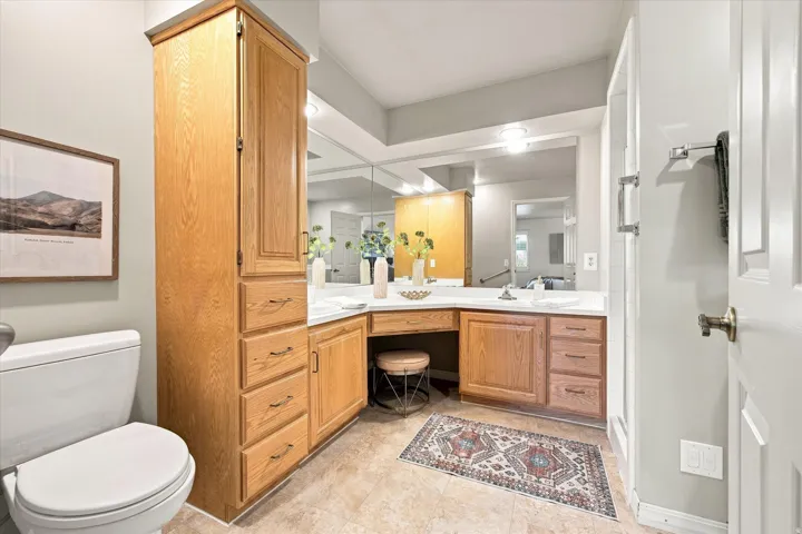 Primary bathroom with shower, double vanity, and accessible walk-in bathtub.