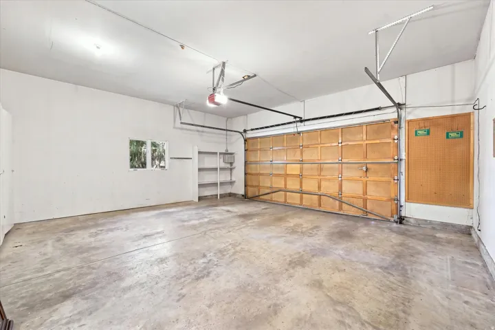 Attached two-car garage with extra high ceilings.