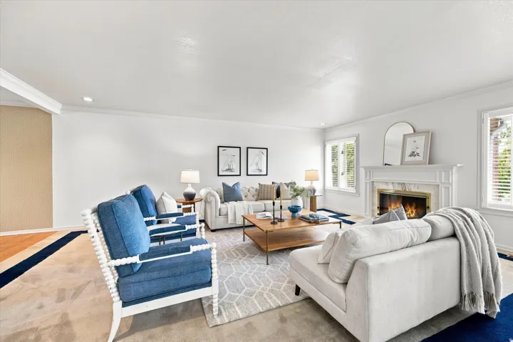 Bright living room with a beautiful marble fireplace.