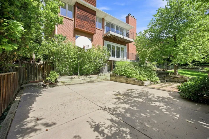 Backyard featuring a basketball area,