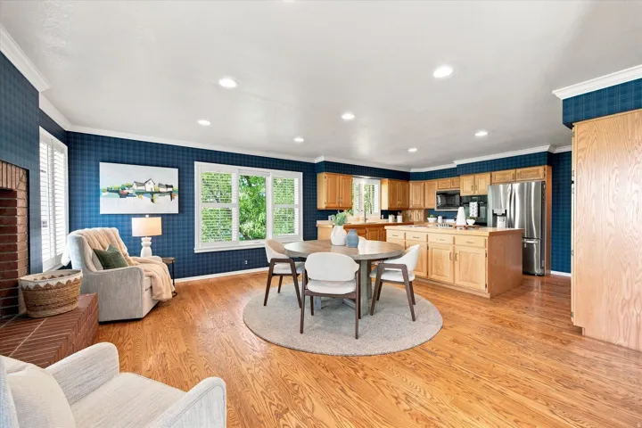 Light-filled, generously sized kitchen with an island, abundant storage, fireplace, and room to gather.