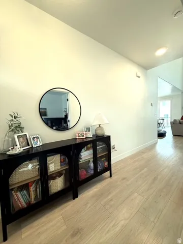 Light-toned wood-finish flooring extending through the space