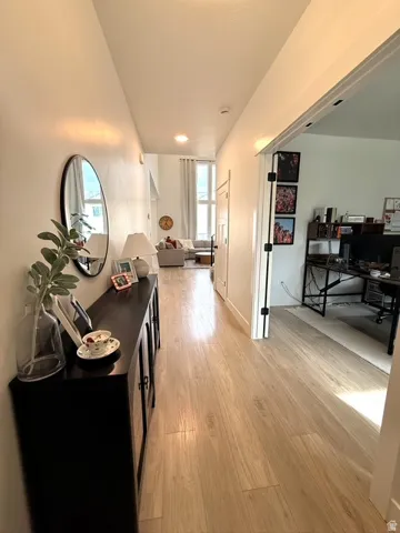 Light wood-finish flooring extends through the hallway