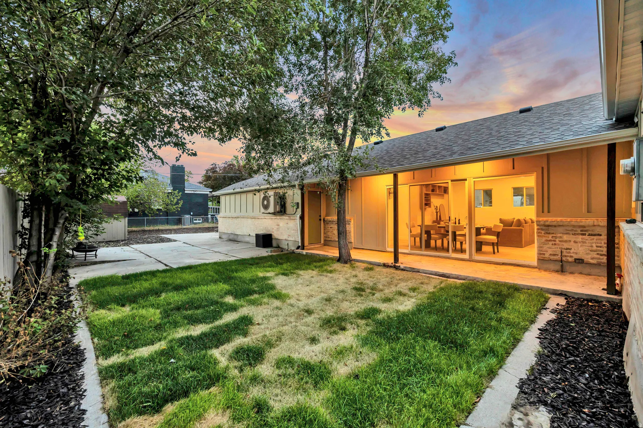 Covered patio with recessed lighting, large sliding glass doors, and brick veneer detailing