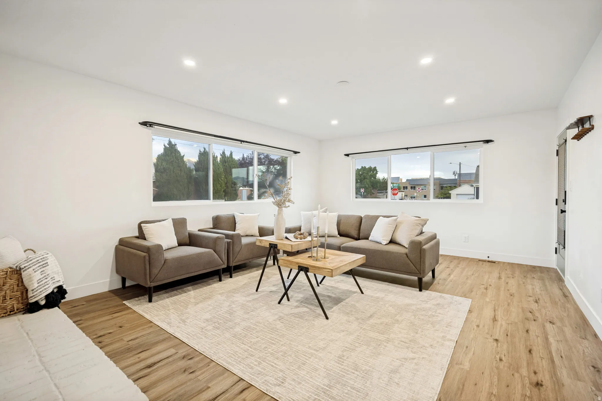 Recessed lighting, wood-finish flooring, white walls, and multiple windows