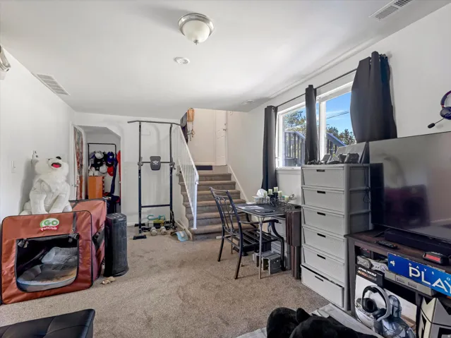 Carpeted flooring, white interior walls, and recessed lighting