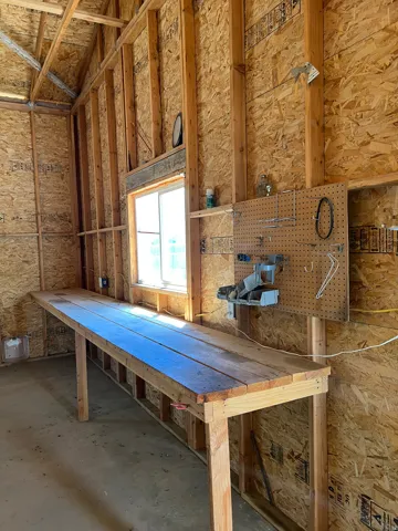 Expansive wooden workbench with natural light from a single window