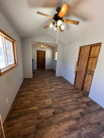 Wood-finish flooring throughout, vaulted ceiling, and recessed windows with wood trim
