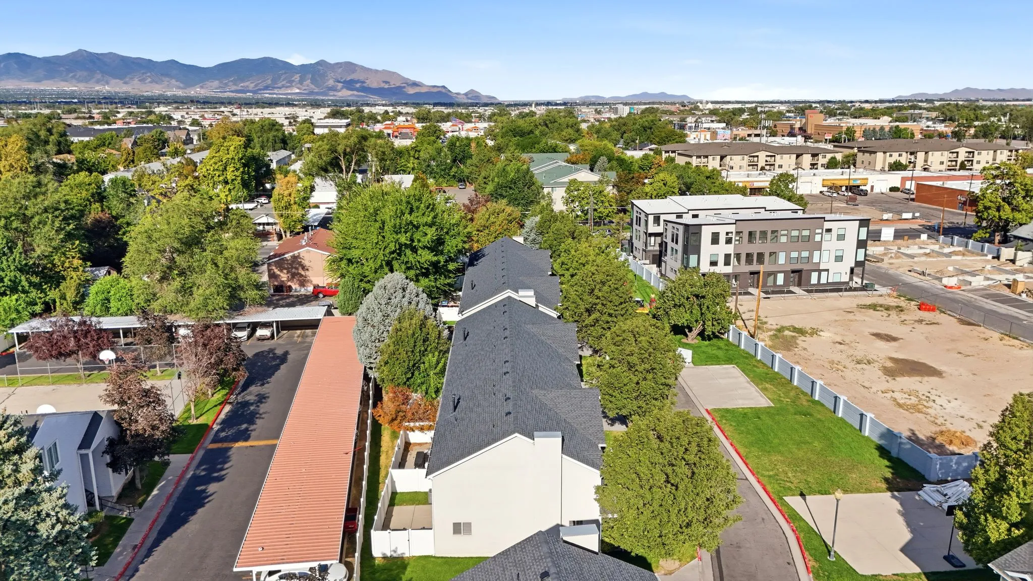 Row of multi-story buildings with dark shingle roofs