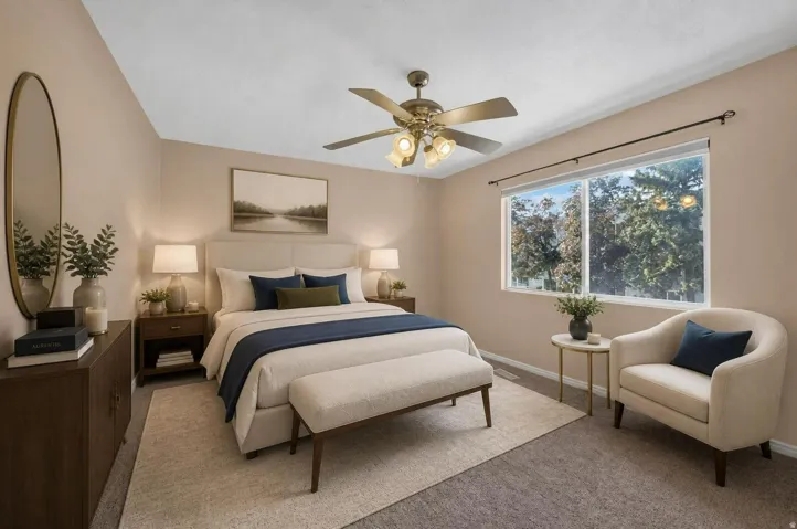 Recessed window with exterior scenery, overhead ceiling fan with lighting, wall-to-wall carpeting, and light-toned wall finishes