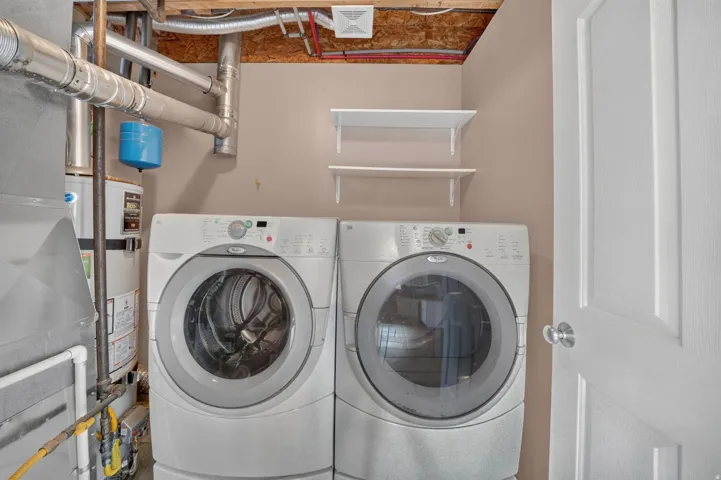 Dedicated laundry area with two wall-mounted shelves