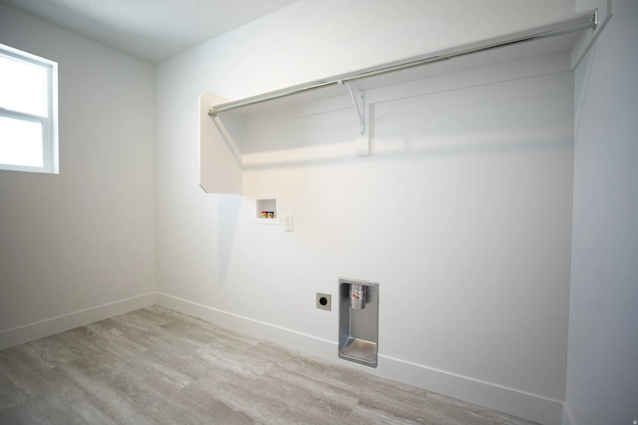 Full-size dedicated laundry room with natural light and washer/dryer hookups.