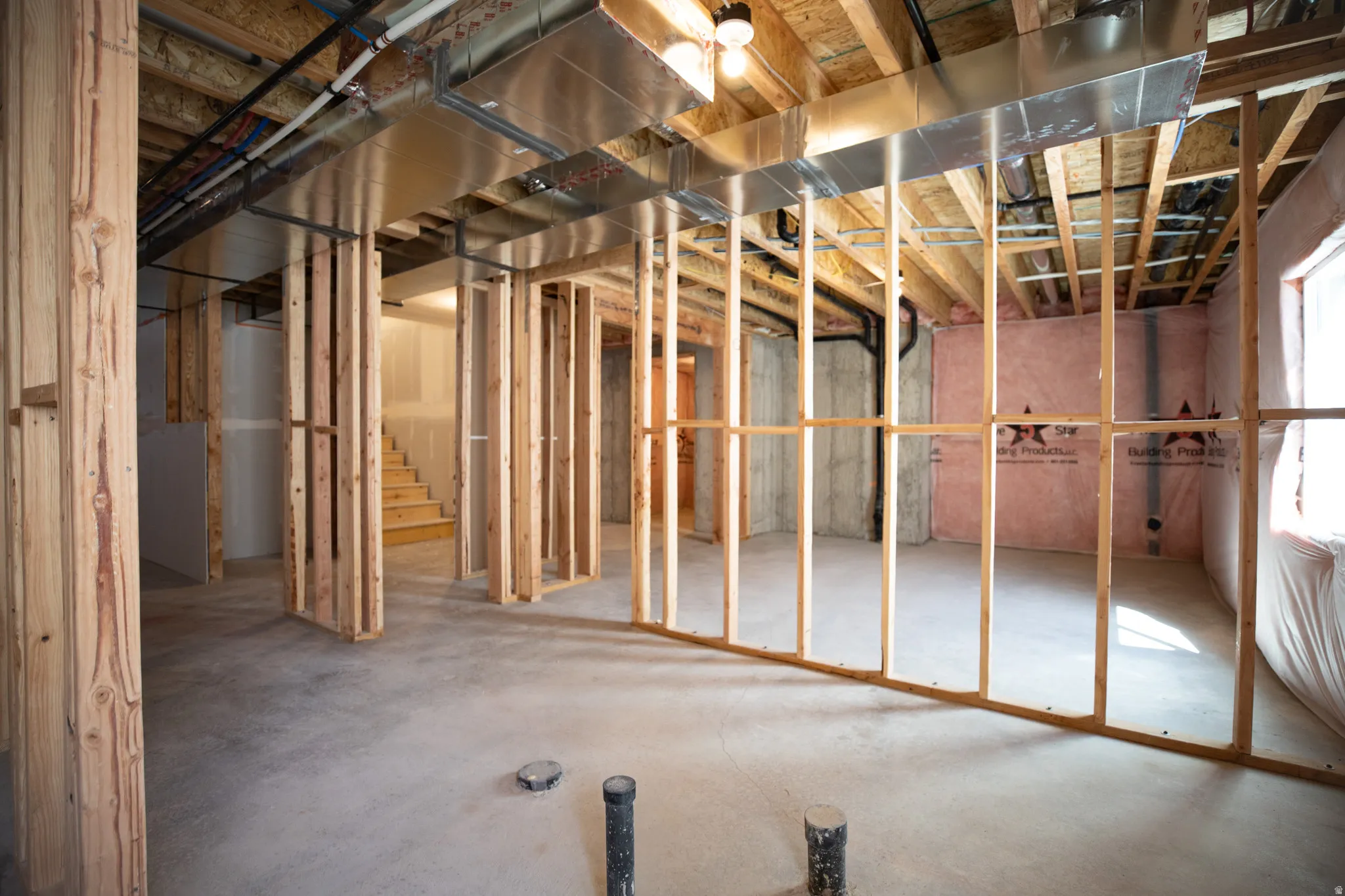 Unfinished basement with potential for large family/game room, a full bathroom and two bedrooms.