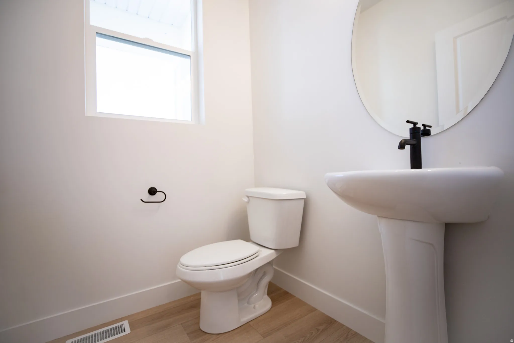 Powder bath on main level adjacent to mudroom and garage.