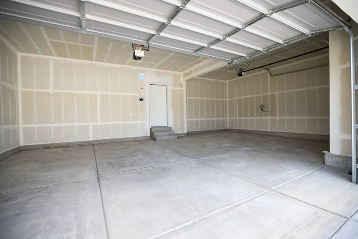 Spacious three-car garage with taped finish.