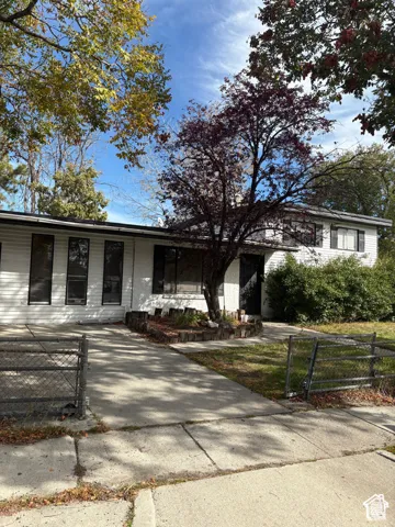 White exterior siding with dark trim windows