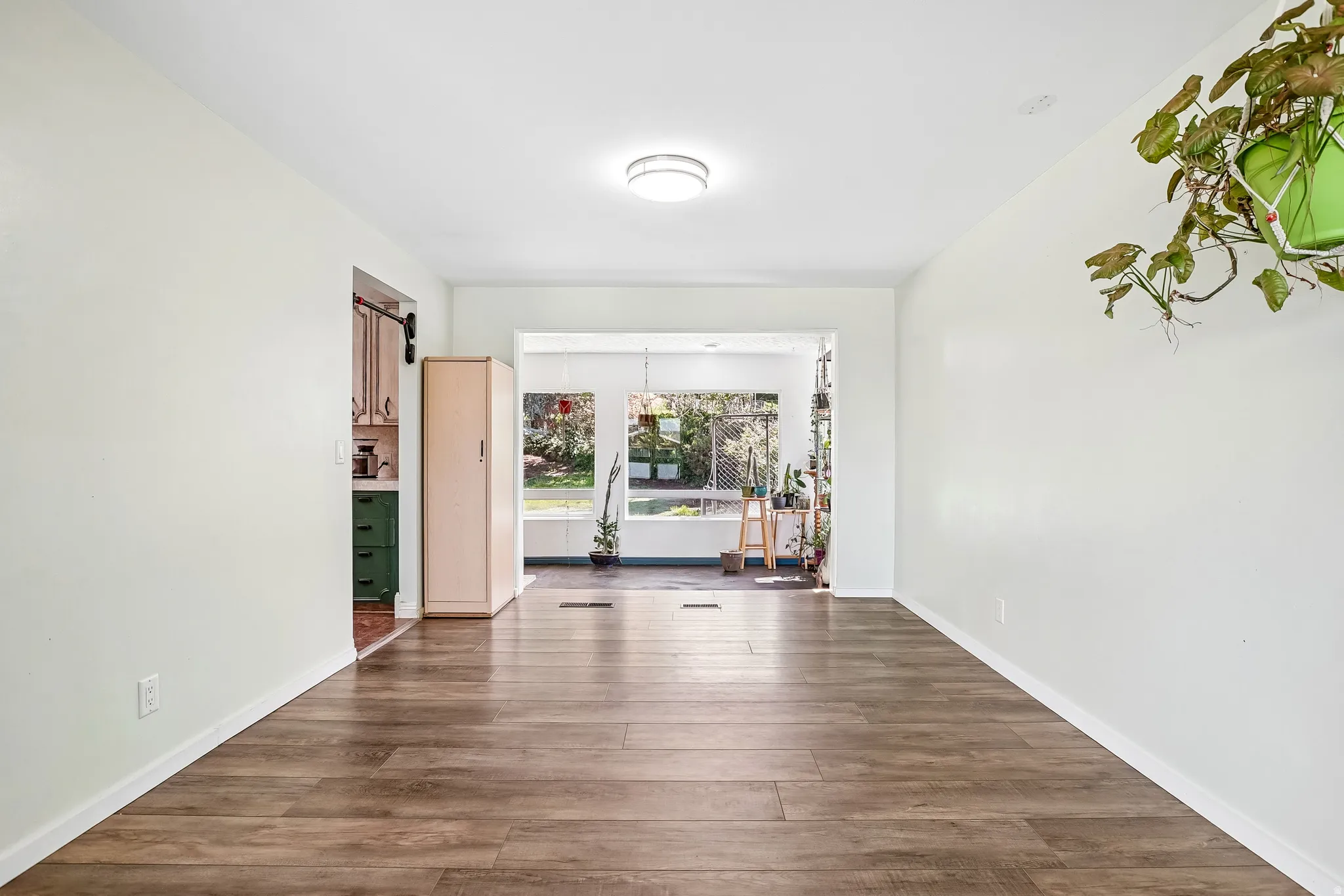 Wood-finish flooring, recessed ceiling lighting, and light-toned walls