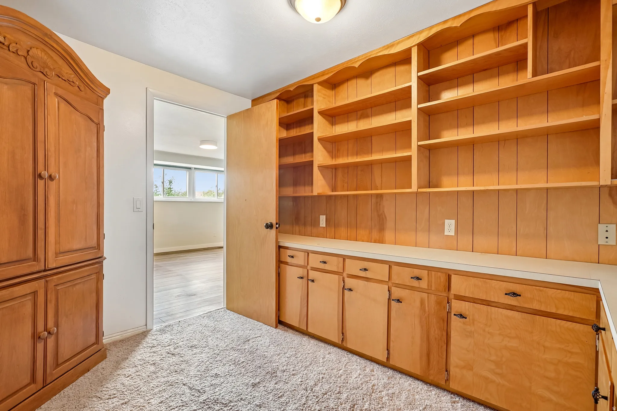 Built-in wood shelving and cabinetry with a light-colored countertop