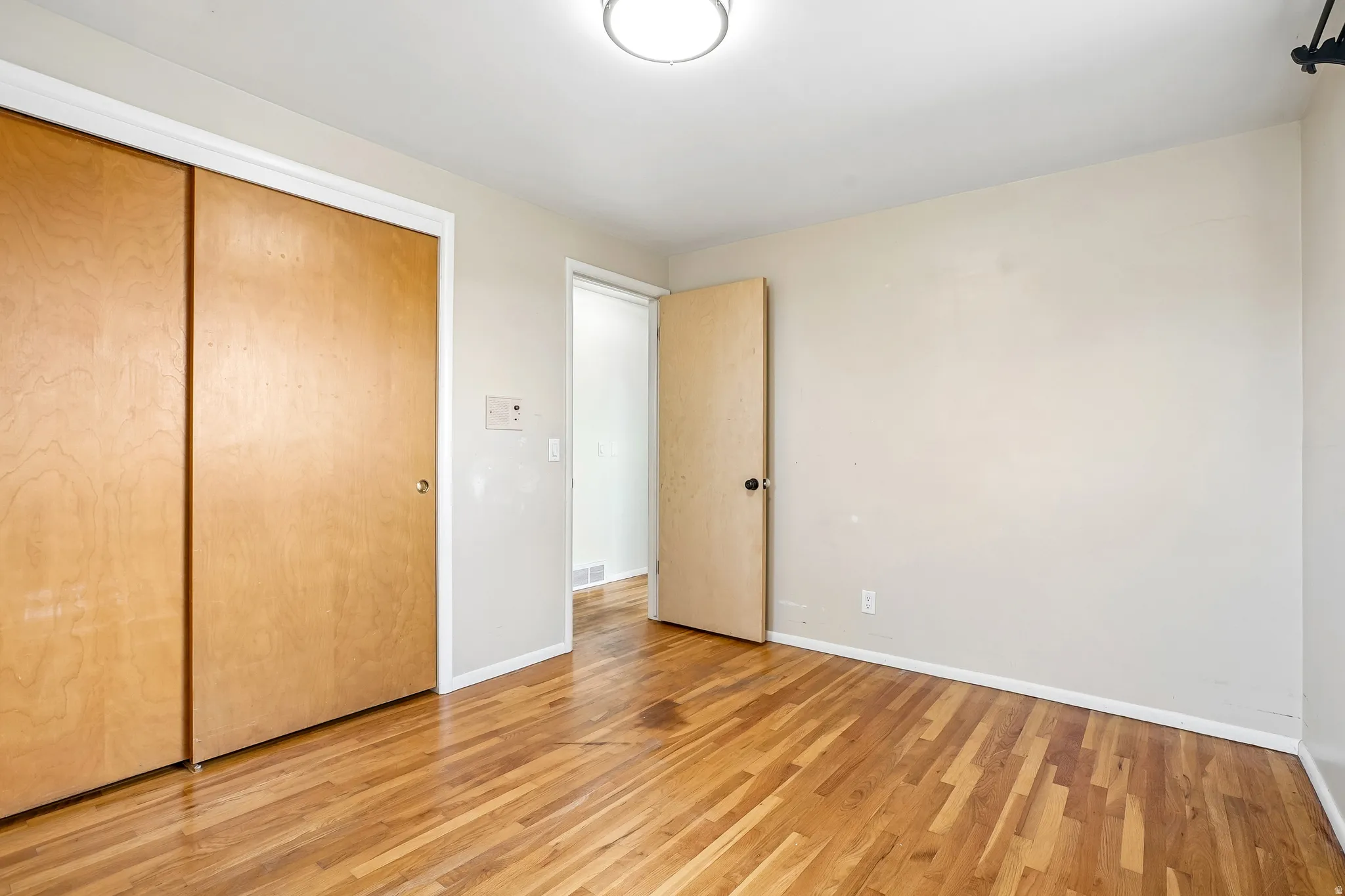 Wood-finish flooring throughout, paired with a light-toned wall finish