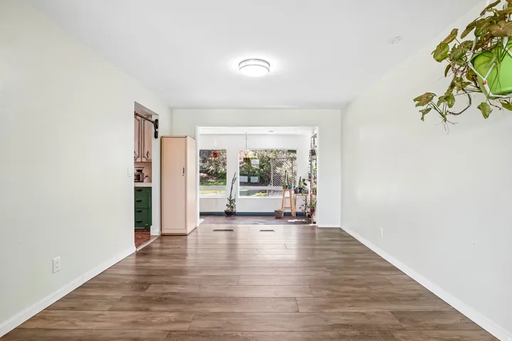 Wood-finish flooring, recessed ceiling lighting, and light-toned walls