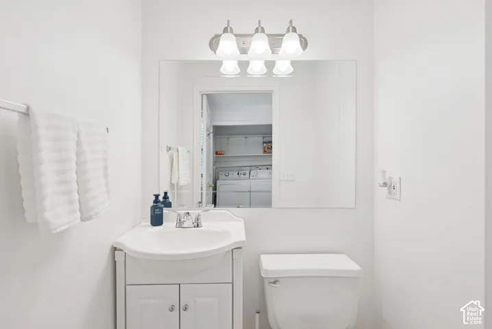White vanity with a single basin sink and chrome faucet