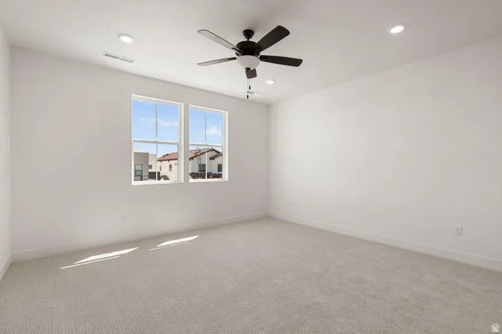 Recessed lighting, ceiling fan, dual windows, and carpeted flooring