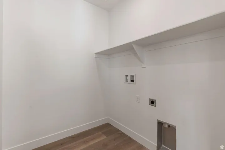Utility room with wood-finish flooring and built-in shelving