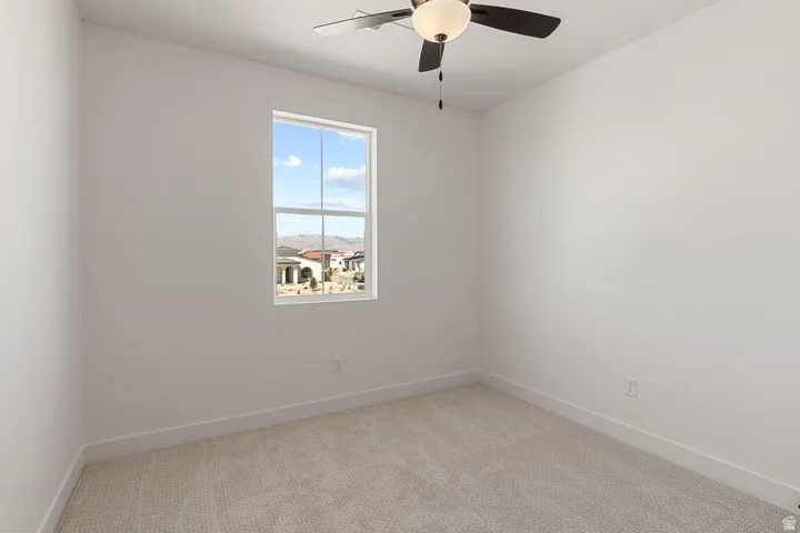 Carpeted flooring, single window, ceiling fan with integrated lighting, white walls, white trim