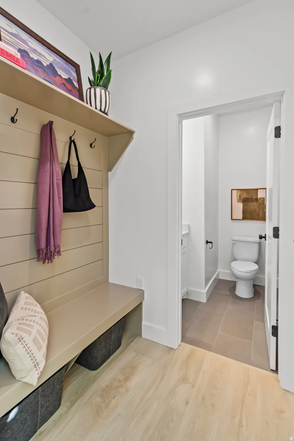 Built-in hall tree with integrated bench seating, upper shelf, and coat hooks