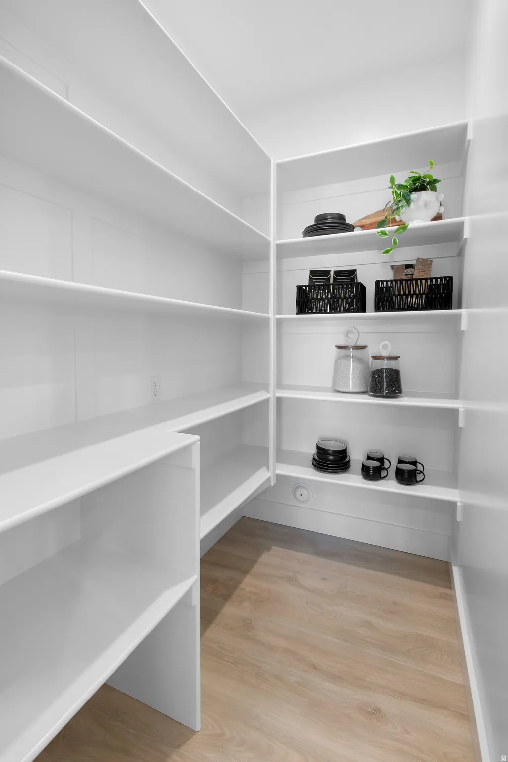 White shelving system with wood-finish flooring