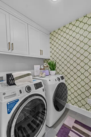 White shaker-style cabinetry with gold-tone hardware