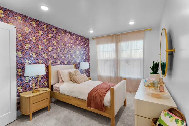 Accent wall with patterned wallpaper, recessed lighting, double windows, light-toned wood-finish flooring, and a built-in closet door