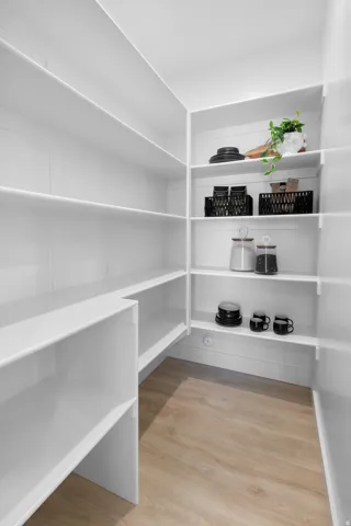 White shelving system with wood-finish flooring
