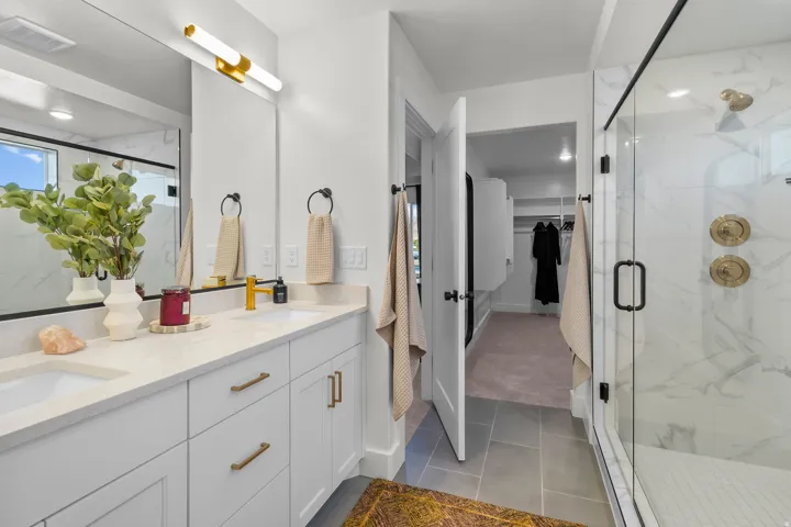 Dual vanity with integrated sinks and gold-finish faucets