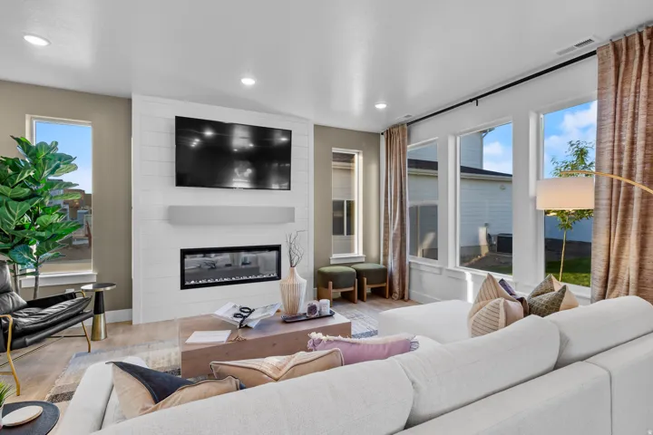Modern living space featuring wood-finish flooring and recessed lighting