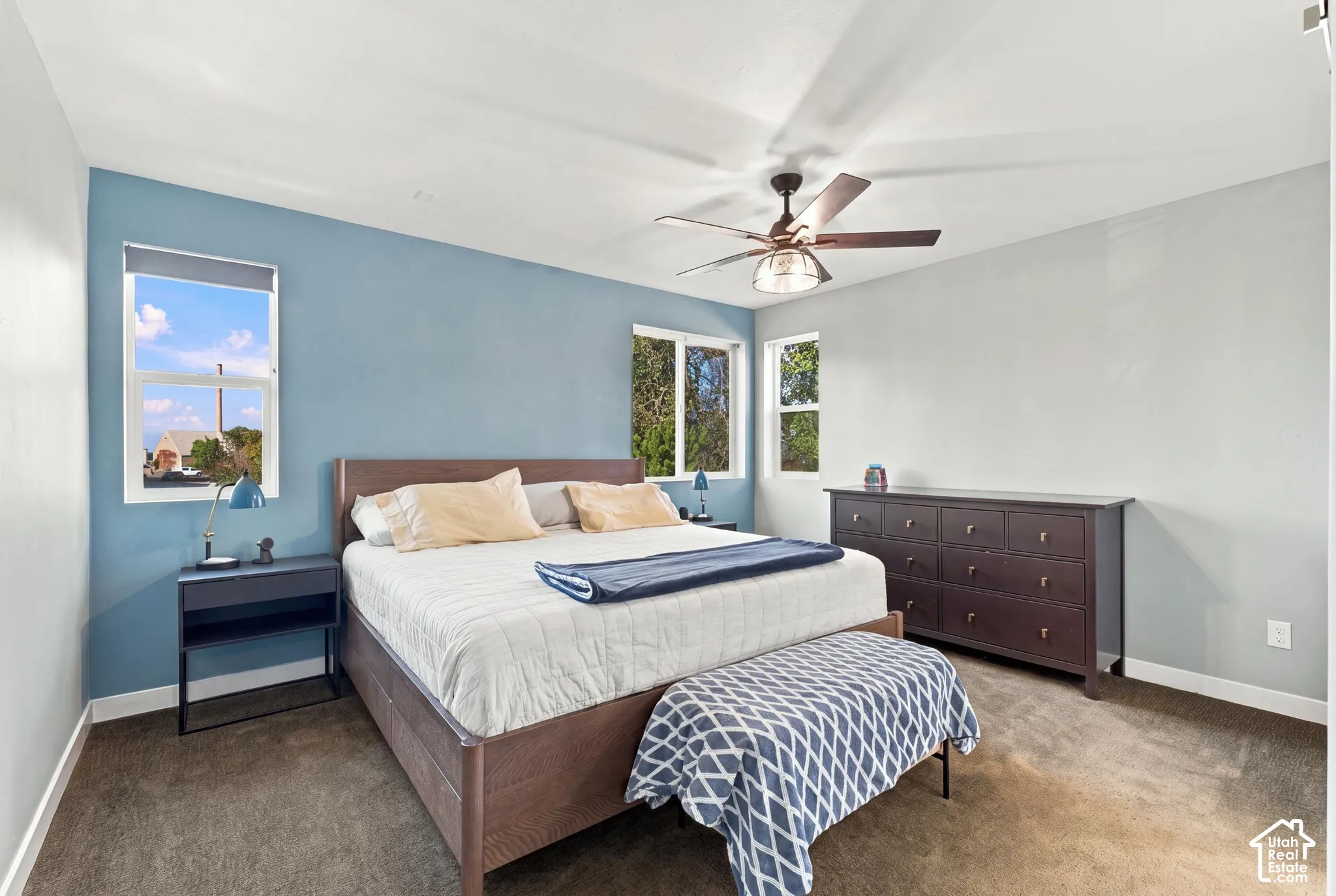 Recessed lighting, ceiling fan with light fixture, multiple windows, and carpeted flooring