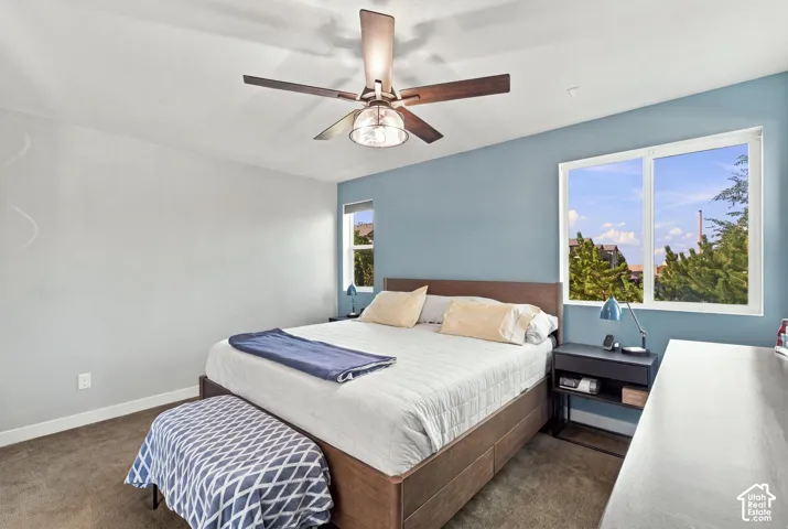 Recessed lighting, ceiling fan with integrated light, window with white frame, light-colored walls, and carpeting
