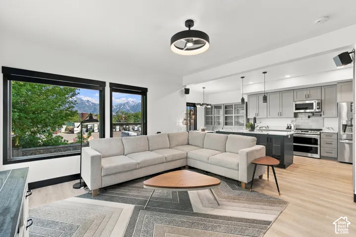 Open-concept living area with light wood-finish flooring