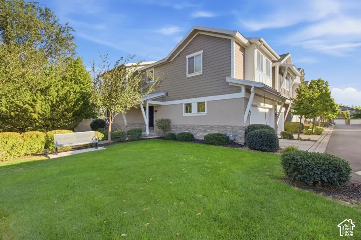 Two-story exterior with horizontal siding, stucco, and stone accents