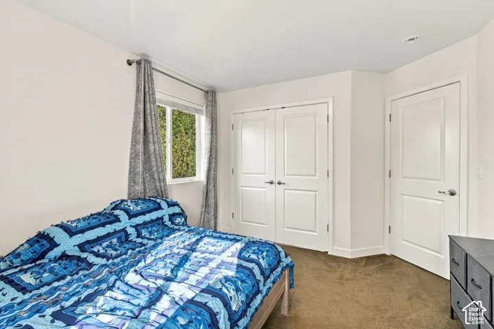 Neutral wall paint, recessed lighting, white interior doors, and warm-toned carpet flooring